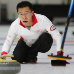 Jason Chang throws a stone for the Hong Kong national curling team