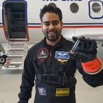 Aaron Persad shows off a small sample of water