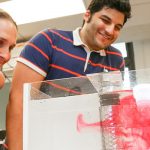 Professor Amy Bilton in a lab with a grad student