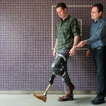 Professor Jan Andrysek and a grad student demonstrate a lower-limb prosthetic device.