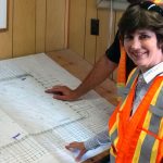 Dawn Tattle in front of blueprints