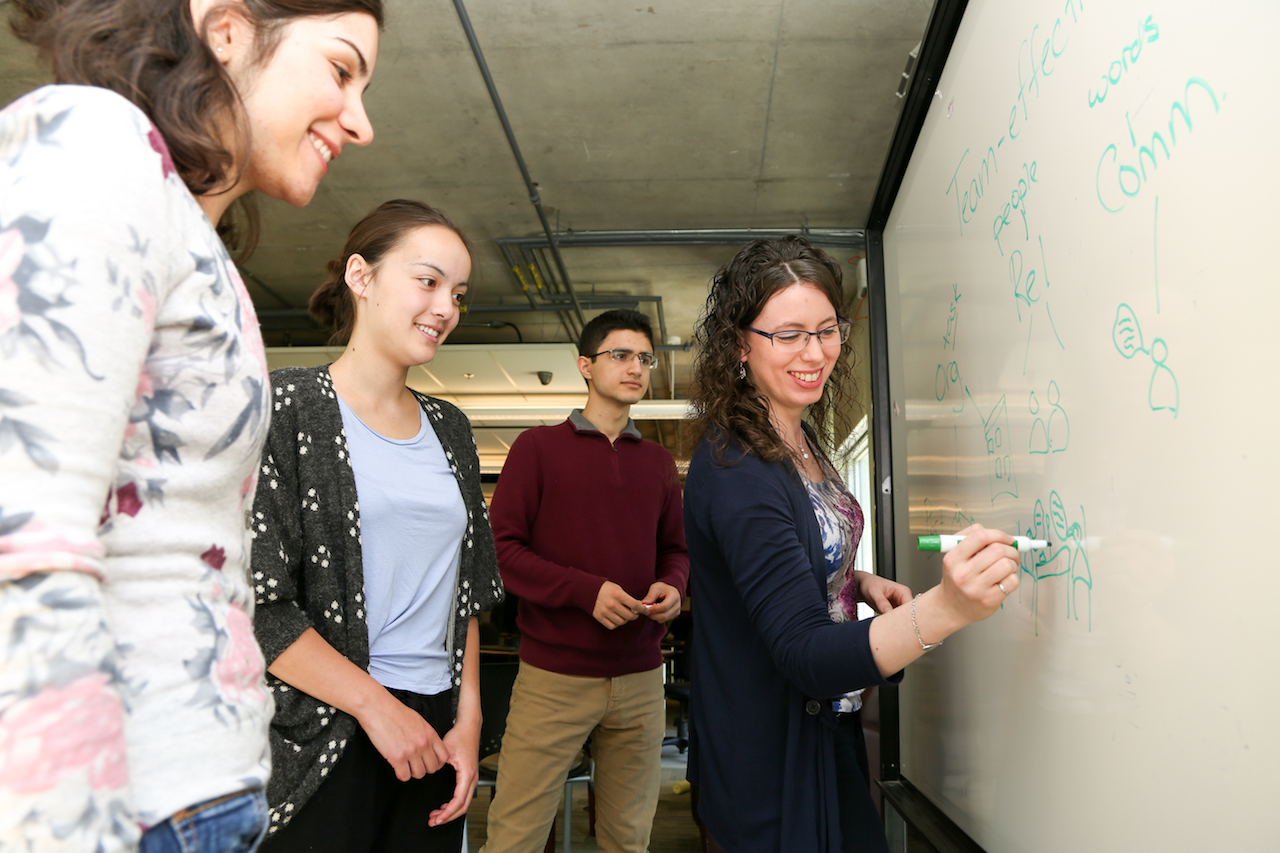 Students learning at a whiteboard