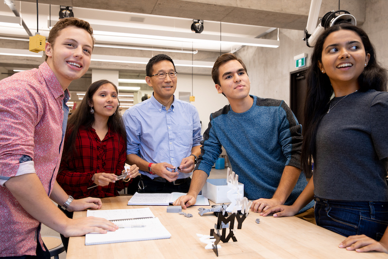 A group of students meet with Dean Chris Yip.