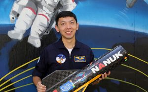 Jeremy Wang holding a rocket