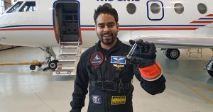 Aaron Persad shows off a small sample of water