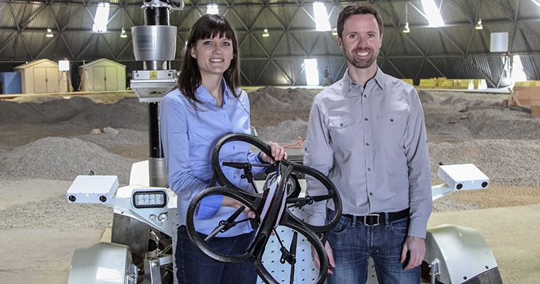Professors Angela Schoellig and Tim Barfoot with a drone